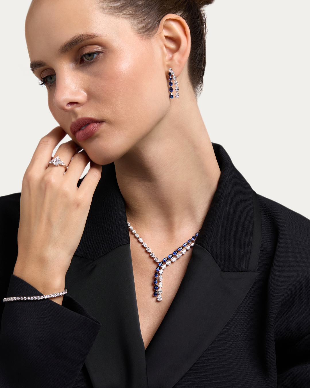 Model in a black blazer wearing a DANI diamond necklace and earrings